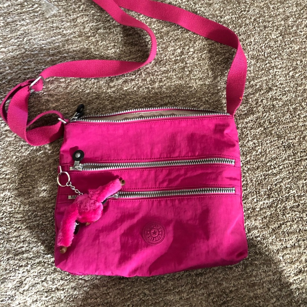 Hot pink Kipling crossbody bag.